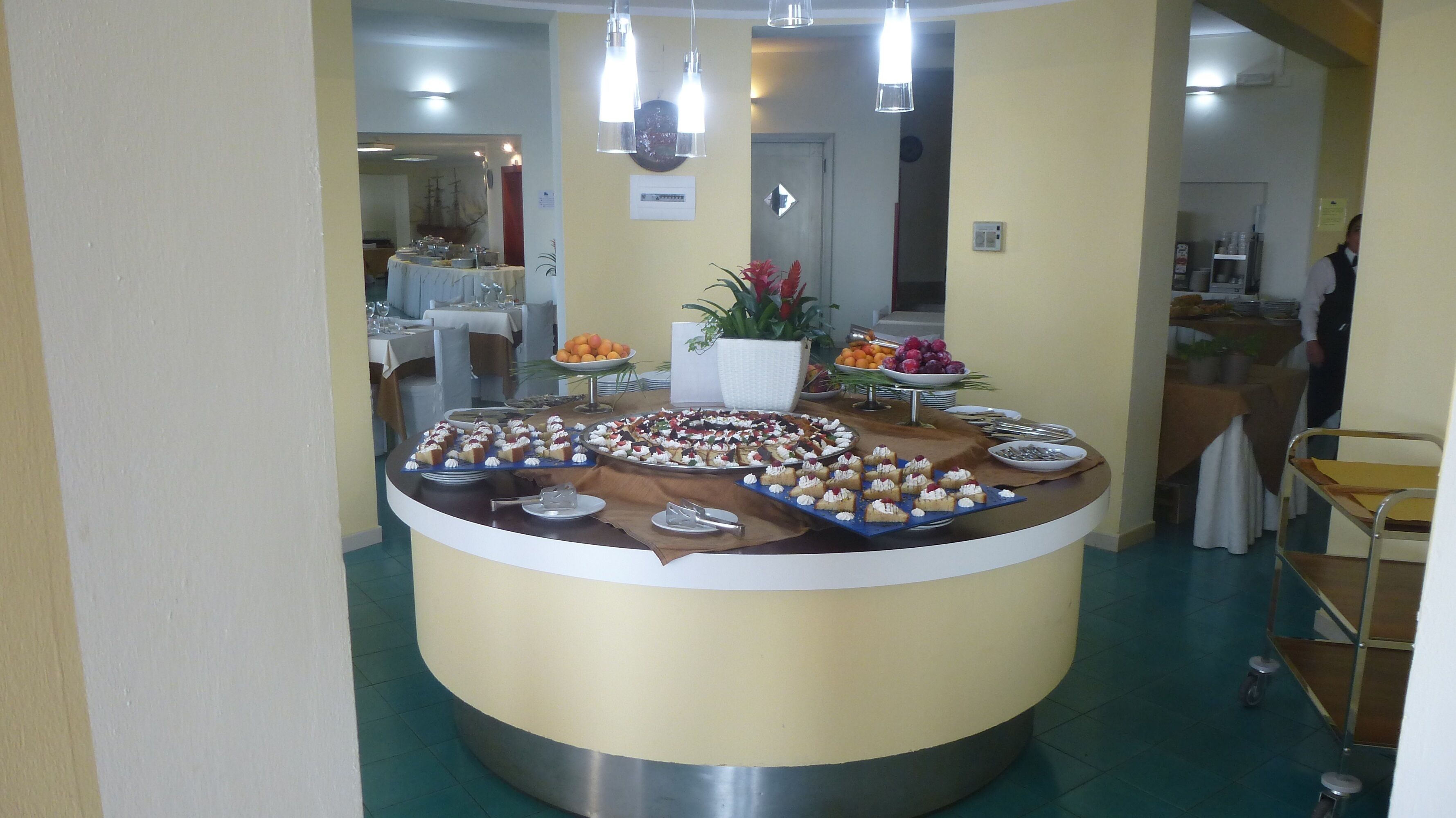 A buffet setup with various desserts and fruits.