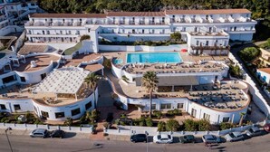 A large resort with multiple buildings, a central swimming pool, and a parking area. - LH Pedraladda Resort (Castelsardo)