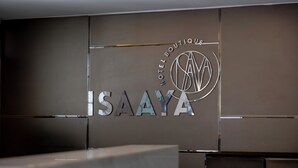 Un letrero de hotel con el nombre "ISAAYA HOTEL BOUTIQUE" y un logotipo.