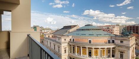 A historic building with classical architecture, featuring a central dome and a courtyard.