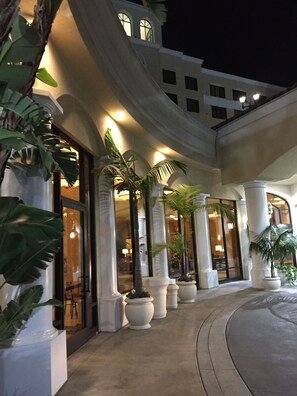 A hotel entrance with large columns, potted plants, and a curved pathway leading to the doors. - DoubleTree Suites by Hilton Anaheim Rsrt - Conv Cntr (Anaheim)
