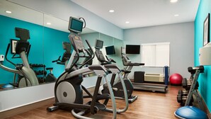 A gym with cardio machines, weights, and a red exercise ball. - Holiday Inn Express Hotel & Suites Panama City-Tyndall by IHG (Panama City)