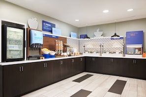 A modern breakfast bar with a variety of food options, including yogurt, eggs, milk, cereal, and hot food. - Holiday Inn Express Hotel & Suites Panama City-Tyndall by IHG (Panama City)