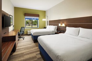 A hotel room with two beds, a desk, a chair, a TV, and a window with a view of greenery. - Holiday Inn Express Hotel & Suites Panama City-Tyndall by IHG (Panama City)