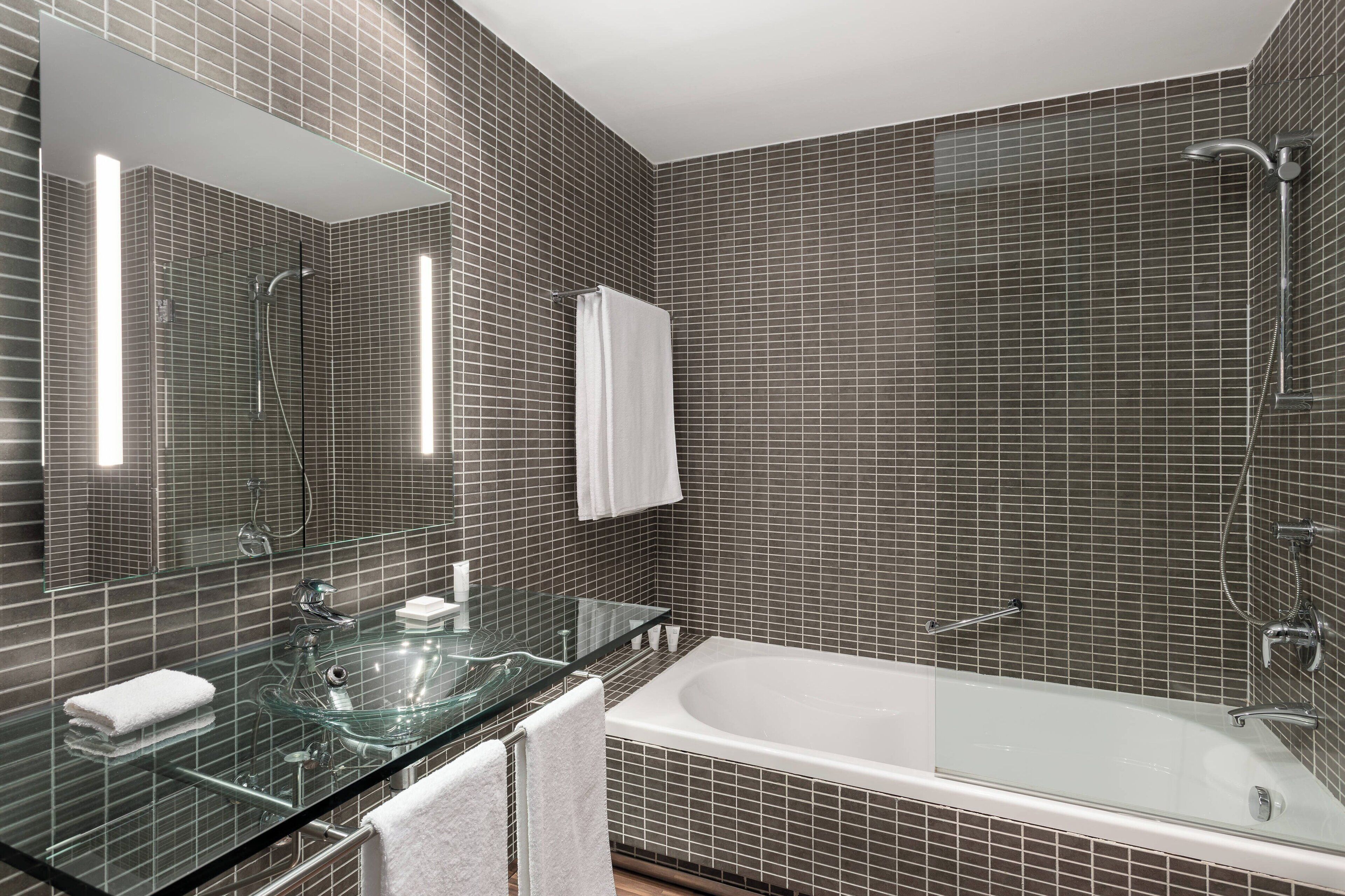 combined shower/bathtub, designer toiletries, hair dryer, slippers