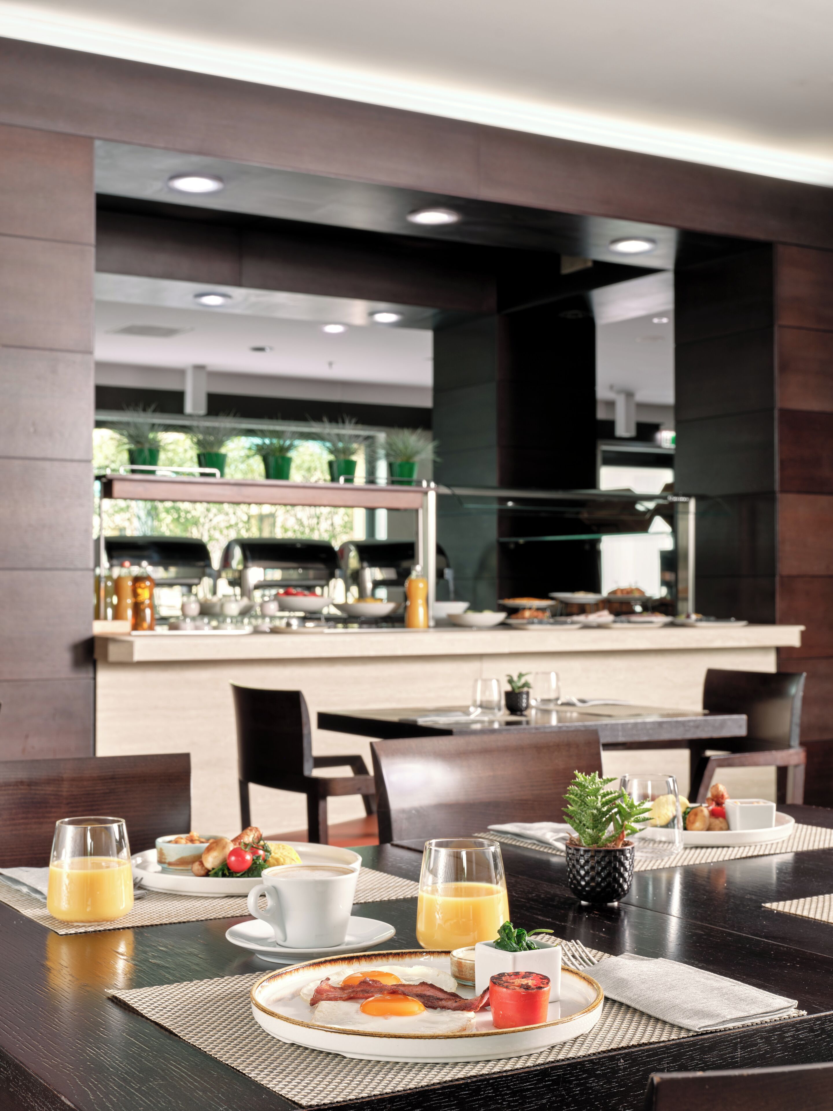 A breakfast setting with a table, chairs, and a view of the kitchen area.