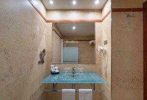 A bathroom with a glass sink, a mirror, a towel rack, and a shower area. - MS Maestranza Málaga Centro (Málaga)