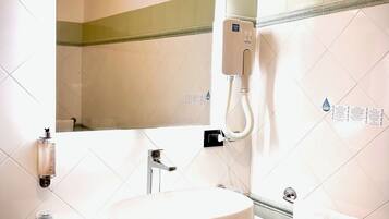 A bathroom with a white sink, a mirror, a towel rack, and a hand dryer.