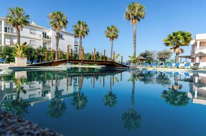 Seasonal outdoor pool, open 9:00 AM to 8:00 PM, pool umbrellas