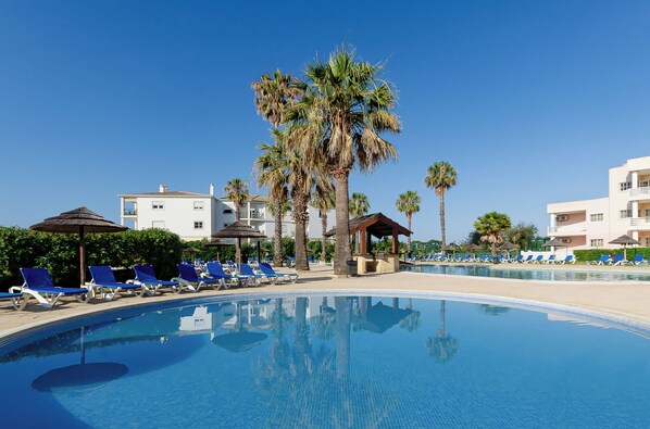 Seasonal outdoor pool, open 9:00 AM to 8:00 PM, pool umbrellas