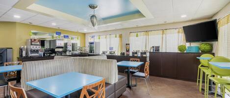 A restaurant with booths, tables, and chairs.