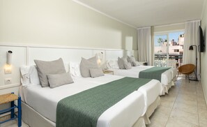 A hotel room with two beds, a chair, a TV, and a balcony with a view. - AQUA Hotel Bertran Park (Lloret de Mar)