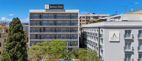 Un hôtel à plusieurs étages doté de balcons, d’un espace piscine et d’une signalétique indiquant « Parc Bertran » et « Hôtel Aqua ».
