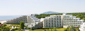 A modern hotel complex with multiple floors, balconies, and a view of the beach and sea. - Laguna Mare Hotel - All Inclusive (Albena)