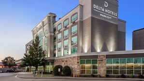 A Delta Hotels Marriott building with a modern design, large windows, and a prominent sign. - Delta Hotels by Marriott Midwest City at the Reed Conference Center (Midwest City)