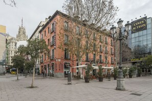 A historic building with a sign for 'Cines Acteon' and a traditional street lamp.
