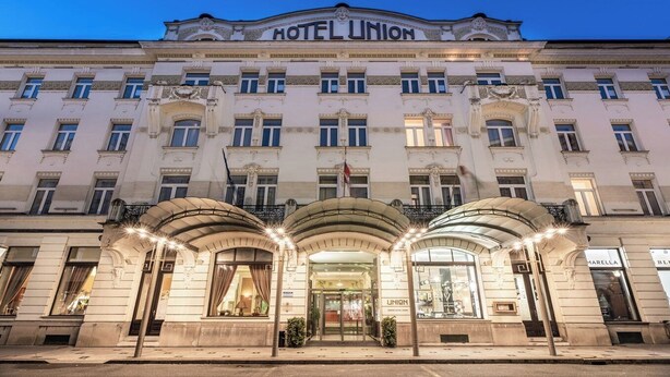 A historic building with a prominent "HOTEL UNION" sign, featuring a classical architectural style with ornate details and a symmetrical facade. - Grand Hotel Union Eurostars (Ljubljana)