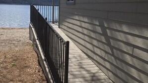 A wooden deck with a metal railing overlooking a lake. - Clear Lake Cottages & Marina (Clearlake)