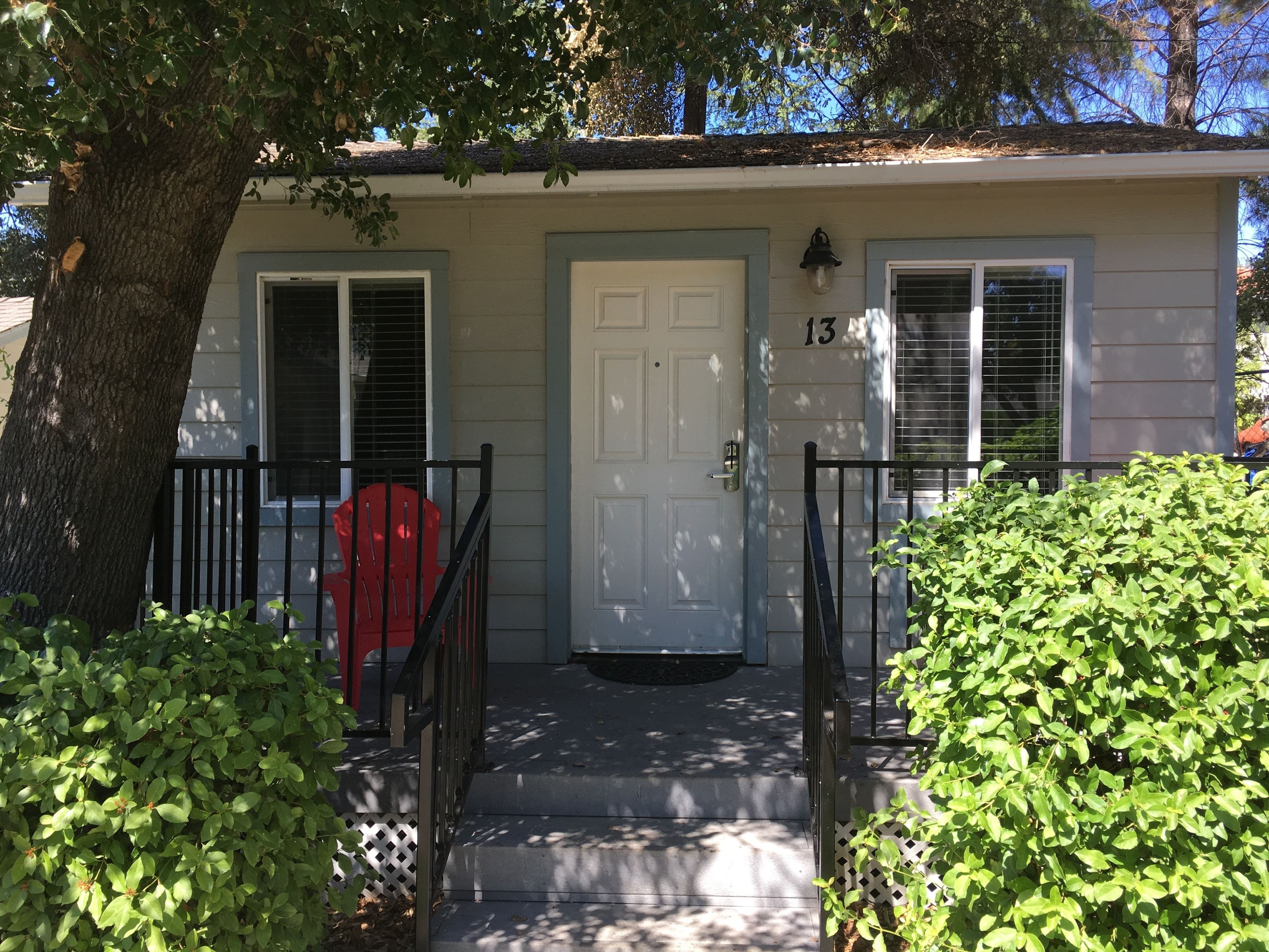 A two-story house with a front door, a mailbox, and a number '13' on the wall.