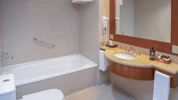 A modern bathroom with a bathtub, toilet, and sink.