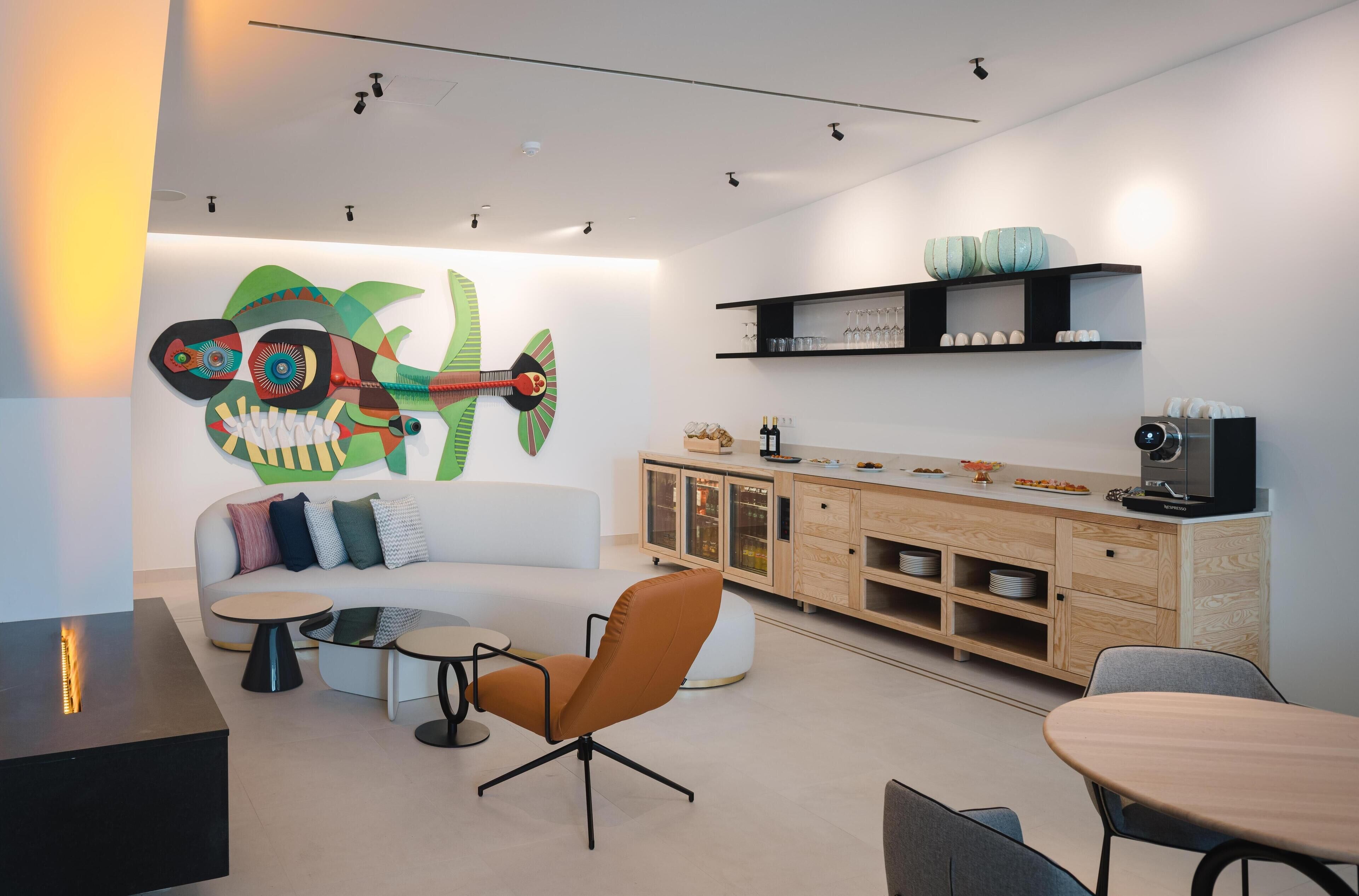 A modern living room with a sofa, coffee table, and orange chair. There is a fireplace, a cabinet with glass doors, and a wall-mounted shelf with decorative items.