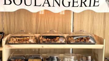 A bakery display with the sign 'BOULANGERIE' above, featuring various baked goods in clear containers.