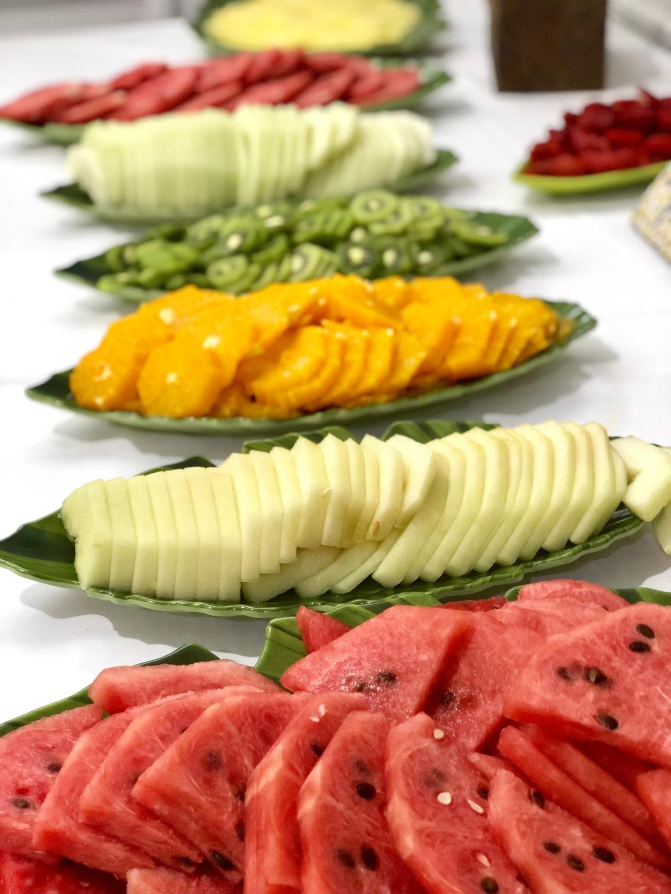A variety of sliced fruits arranged on a table.
