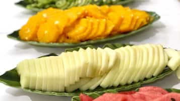 A variety of sliced fruits arranged on a table.