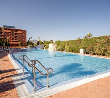 Una piscina cubierta, una piscina al aire libre de temporada, sombrillas