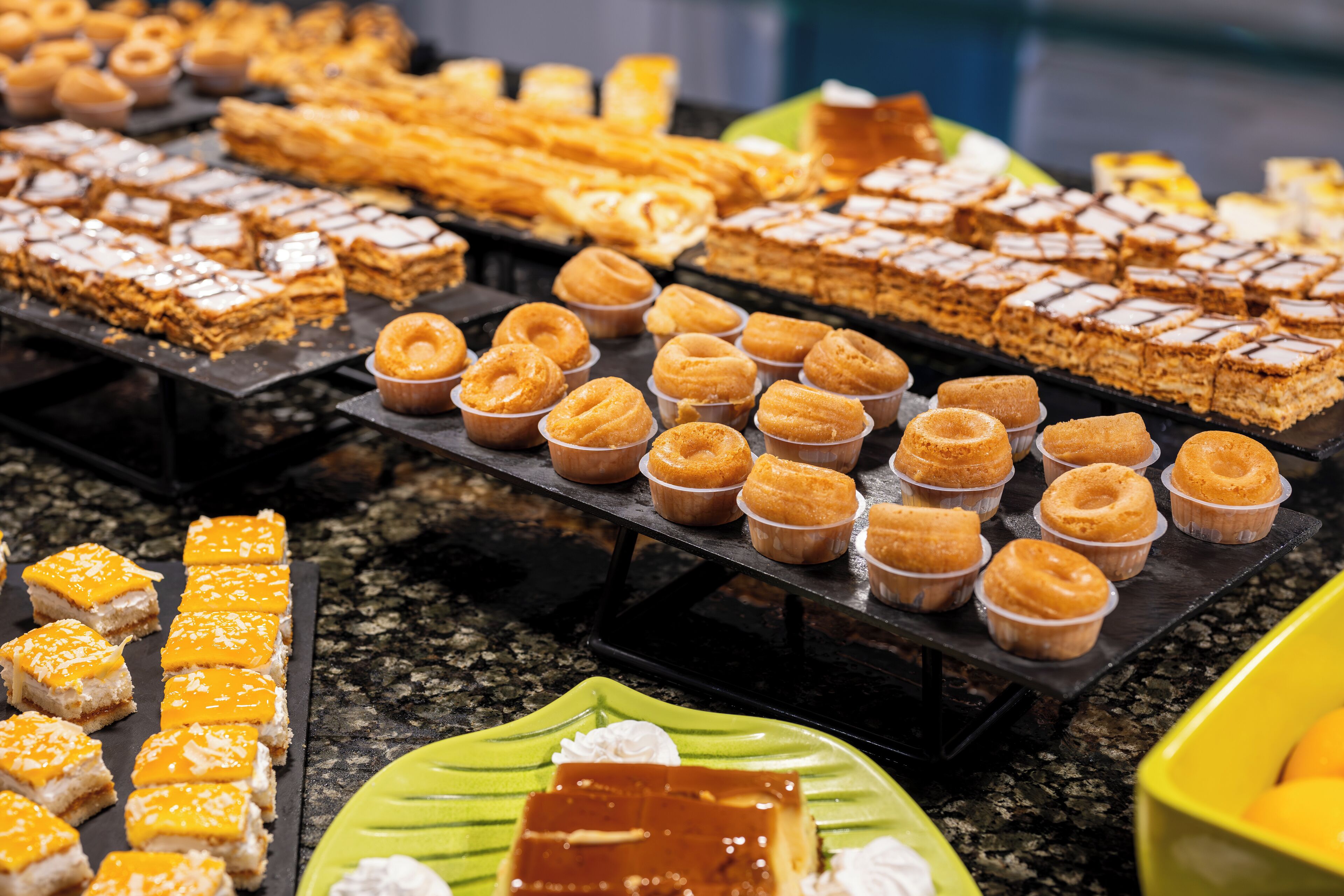 A variety of desserts on display, including pastries, cakes, and tarts.