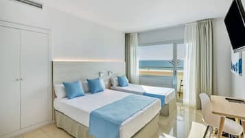 Enjoy a serene beach view from the comfort of this stylish room, featuring two single beds and a flat-screen TV.
