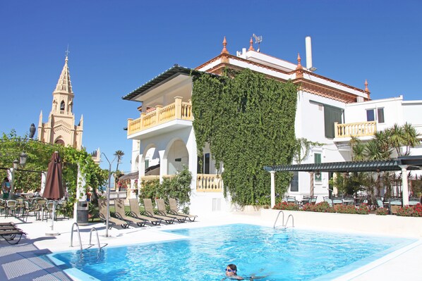 Seasonal outdoor pool, pool umbrellas, pool loungers