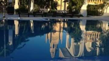 Seasonal outdoor pool, pool umbrellas, pool loungers