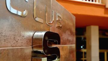 A metallic sign with the word "CLUB" and a keyhole design.