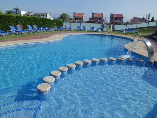 Outdoor pool, open 10:00 AM to 8:00 PM, pool umbrellas, pool loungers