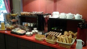 A breakfast buffet with various food items and coffee machines. - Hotel Carmin (Le Havre)