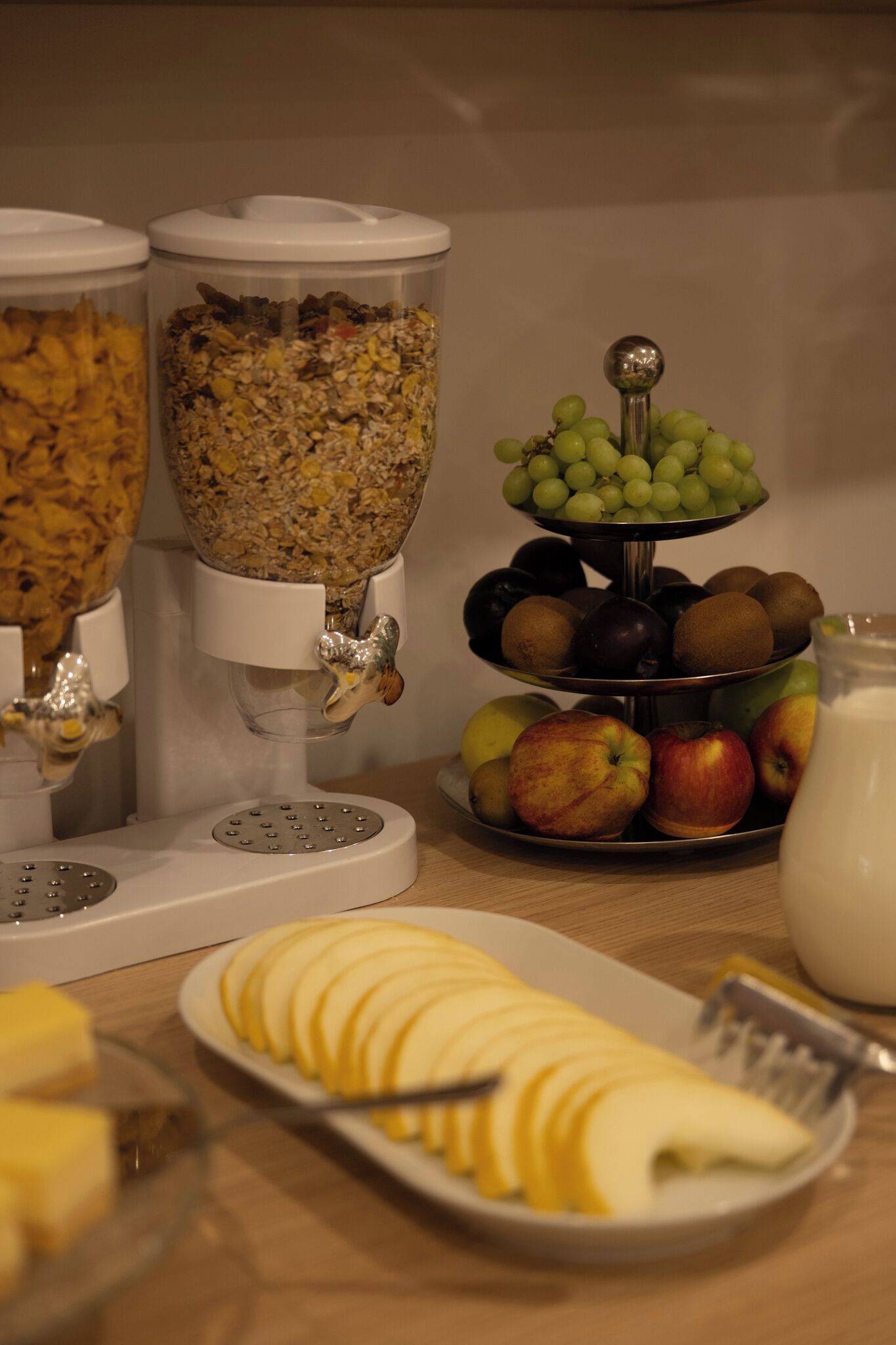 A breakfast buffet with various food items and a milk jug.