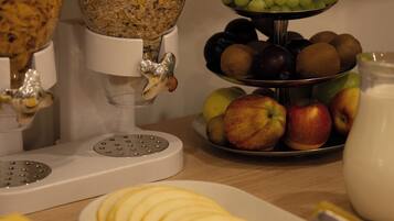 A breakfast buffet with various food items and a milk jug.