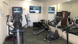 A hotel fitness center with cardio machines, free weights, and a mirrored wall. - Holiday Inn Express & Suites Woodward by IHG (Woodward)