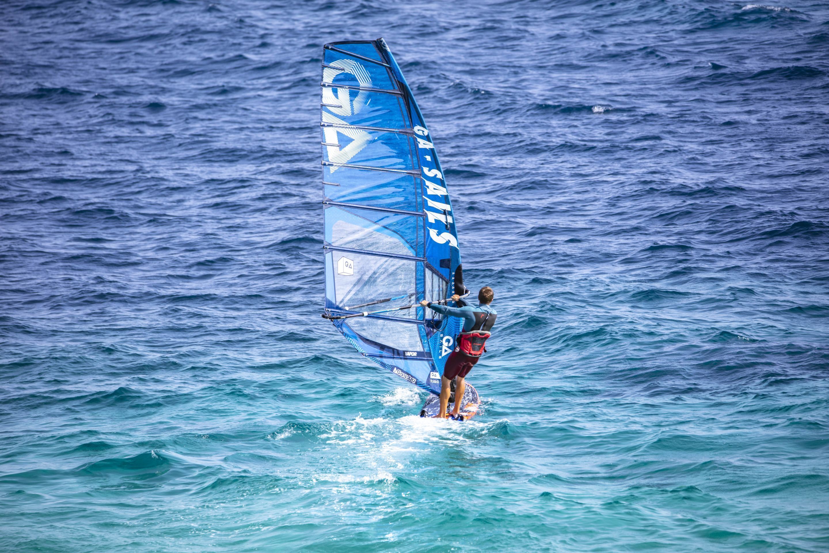A person windsurfing on a body of water.