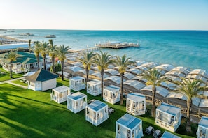 A coastal resort with multiple bungalow-style accommodations, a pier extending into the sea, and a well-maintained lawn area. - Papillon Ayscha Resort & Spa - All Inclusive (Serik)