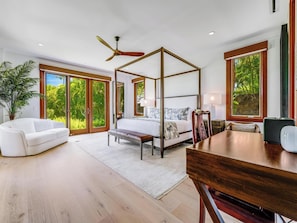 A spacious bedroom with a four-poster bed, a ceiling fan, large windows, a dining table, and a white sofa. - Wailea Beach Villas (Kihei)