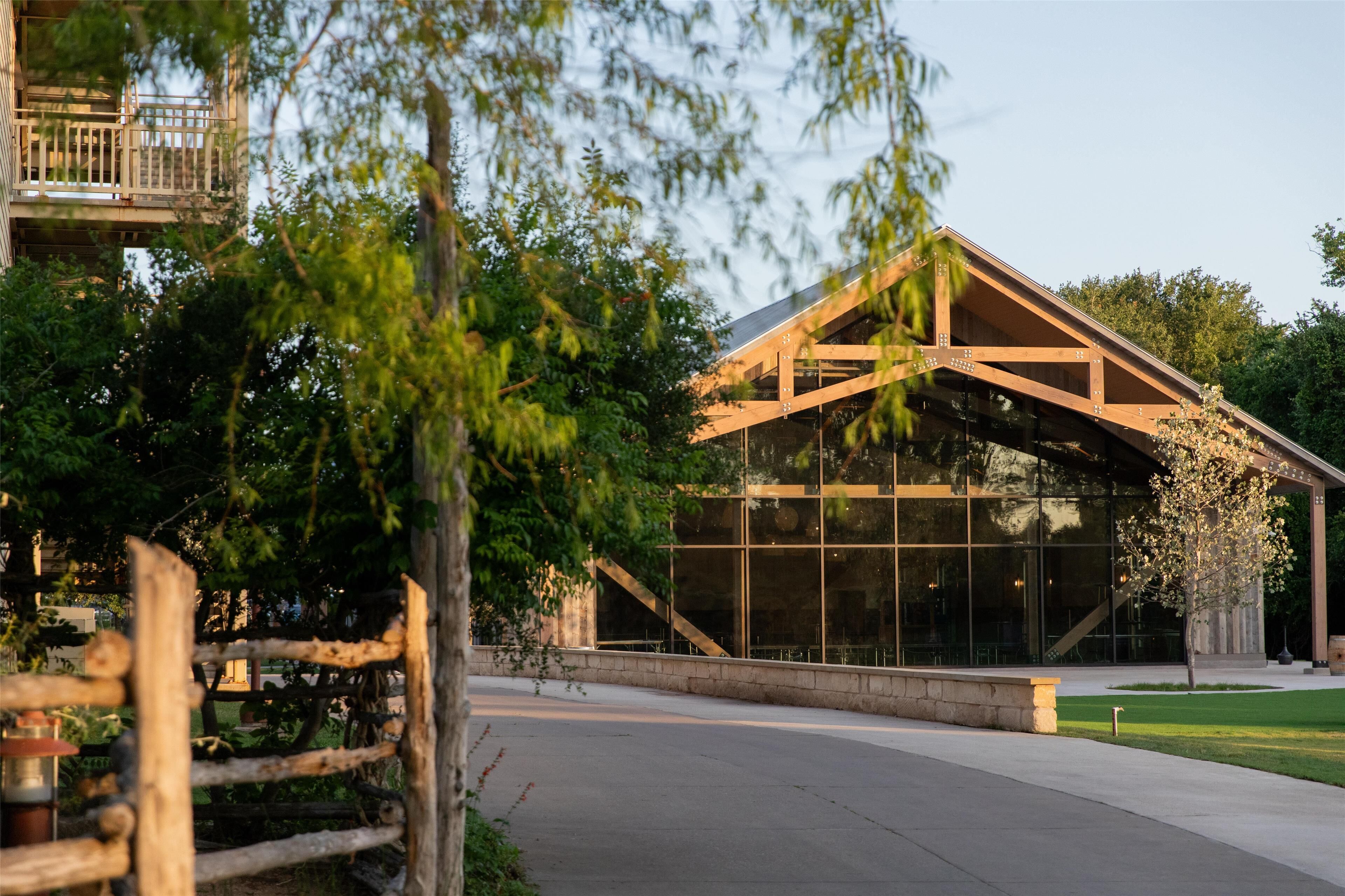 A modern building with large glass windows and a wooden structure.