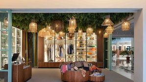 A boutique hotel lobby with a central seating area, a shoe display, and a reception desk. - Valentin Sancti Petri (Chiclana de la Frontera)
