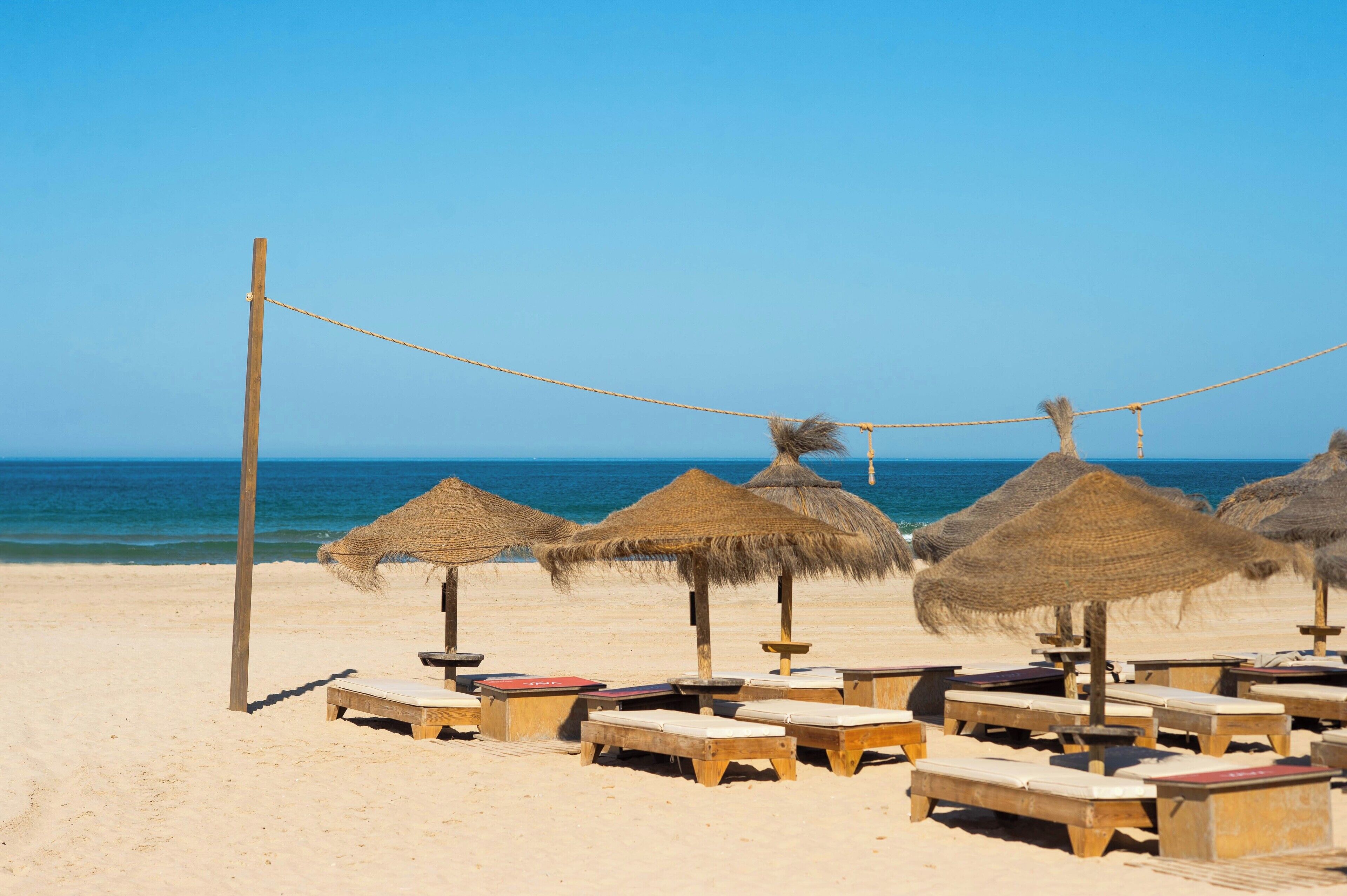 on the beach, white sand, sun-loungers, beach umbrellas