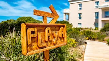 On the beach, white sand, sun-loungers, beach umbrellas