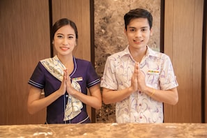 Two individuals in a room with wooden paneling and a marble countertop. - The Seasons Bangkok Huamark (Bangkok)