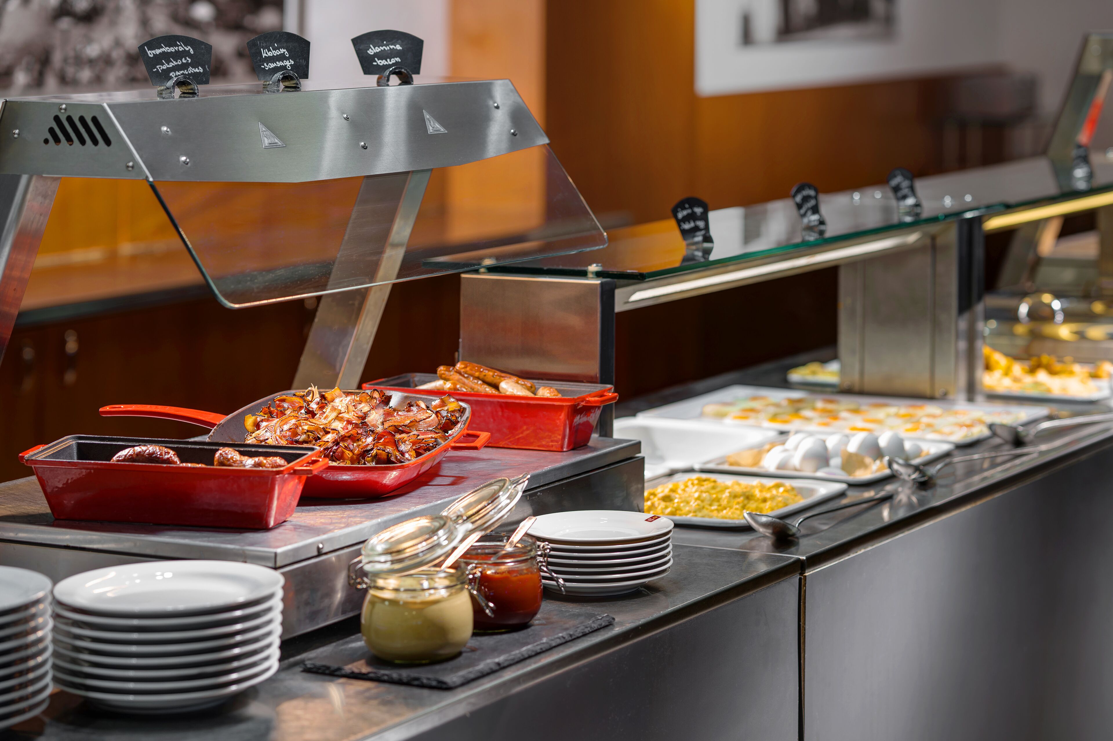 A buffet setup with various food items and condiments.
