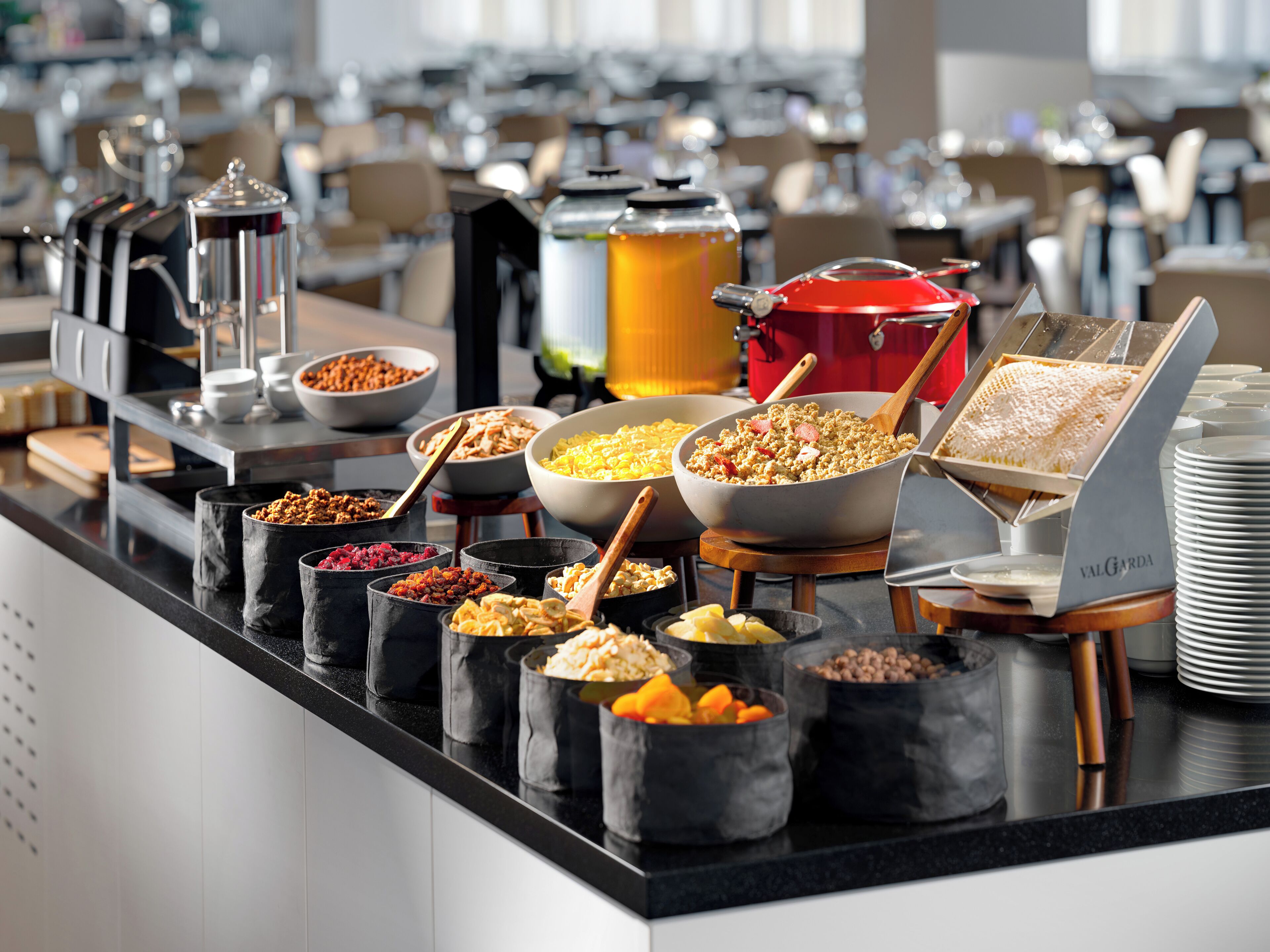 A buffet with various food items and a coffee machine.