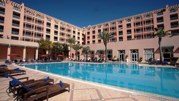 Seasonal outdoor pool, open 10:00 AM to 7:00 PM, pool umbrellas